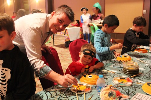 Oliver (Daddy assisting) painting his pumpkin mask.