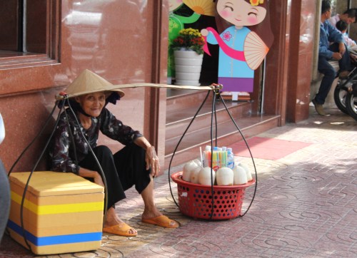 This lady was trying to get us to buy her wares.  She looks so fragile and the buckets look so heavy.  No wonder she is sitting.