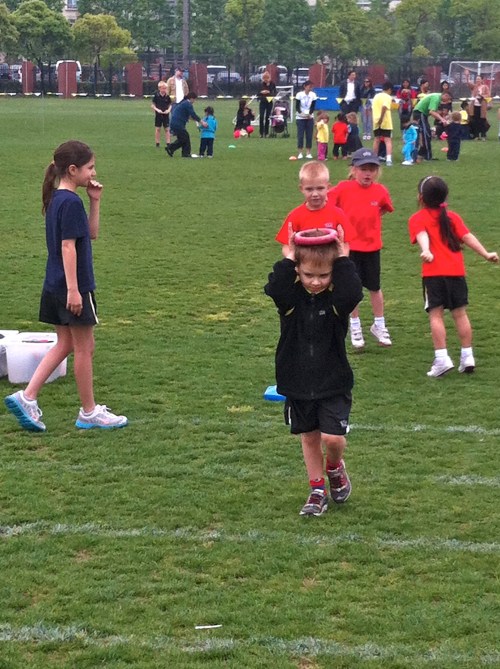 Balancing the hoop on his head.