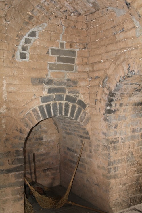 Fire was used to signal to other watch towers, so when the guards/soldiers wanted to eat or stay warm, they had to light fires in chimneys like this one.  It would have been incredibly smokey in here!