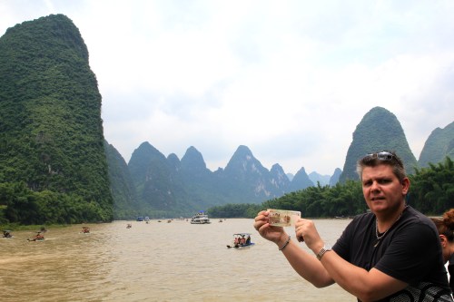Owen holding the 20 RMB note at the spot on the cruise where it is reproduced from. 