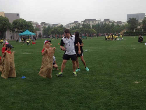 Jumping as high as he possibly can while getting encouraged by the coach!